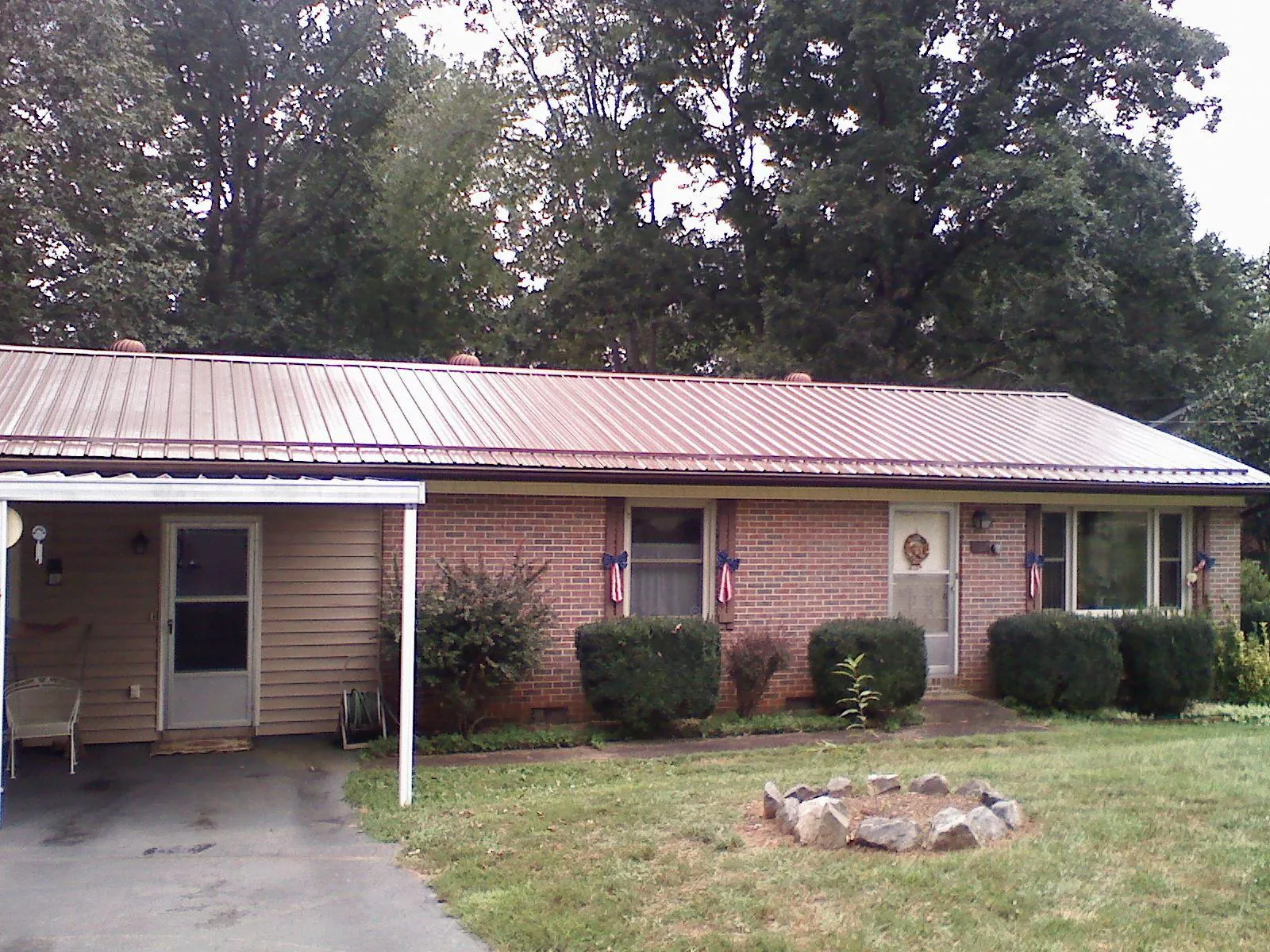 Bronze metal roof and carport on a brick ranch home — Roof Repair work by our crew in Le Center
