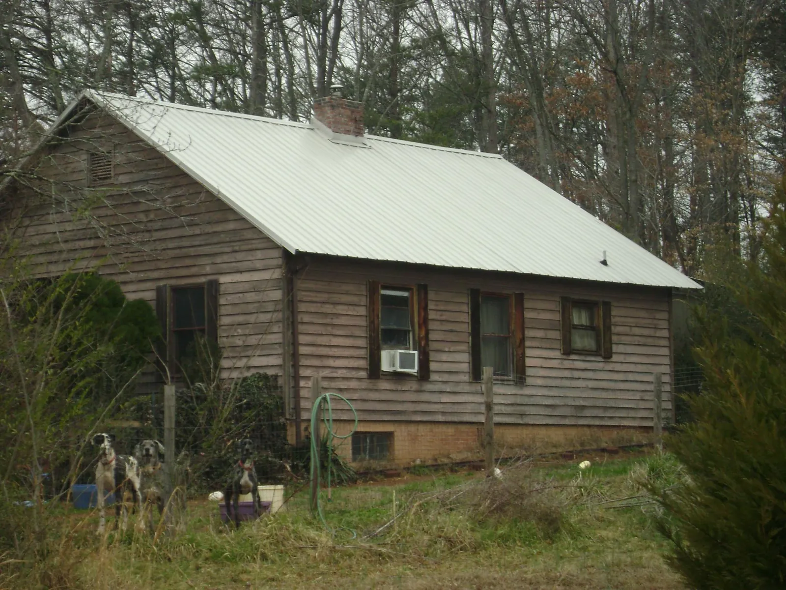White metal roof on an old wood sided farmhouse, from a Metal Roof Installation job in Le Center